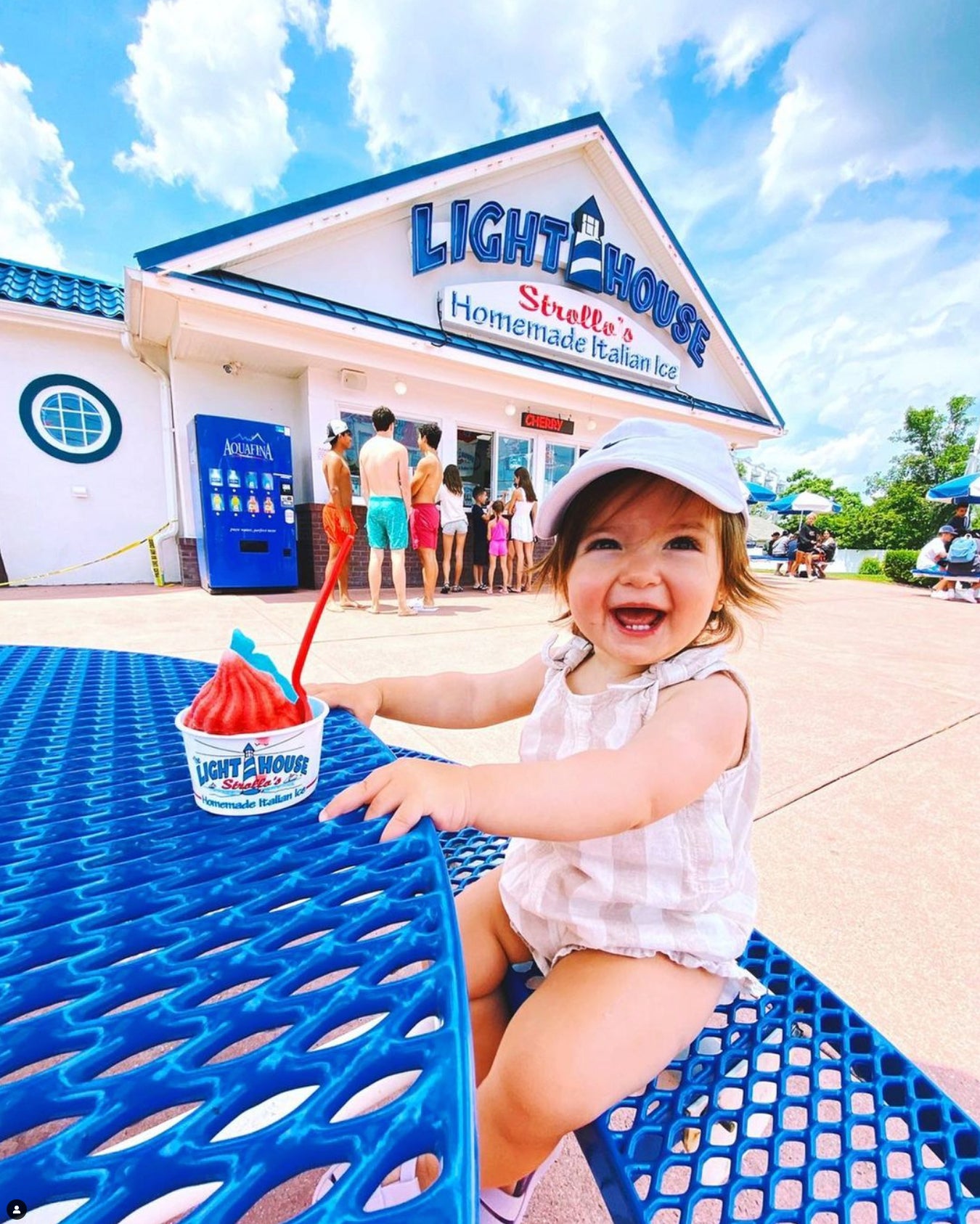 A toddler enjoying a cup of Strollo's Lighthouse homemade Italian Ice