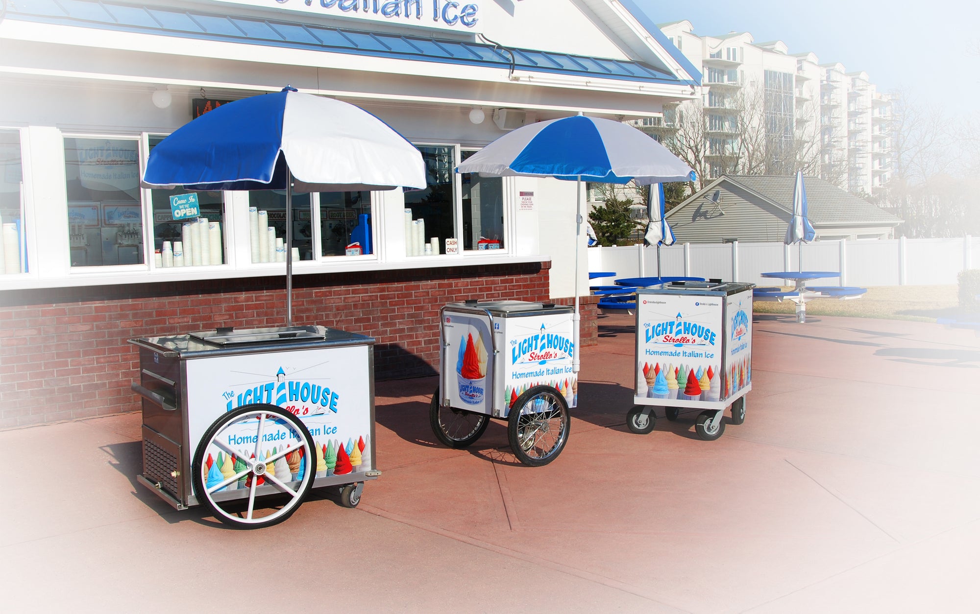Strollo's Lighthouse homemade Italian Ice carts with blue and white umbrellas