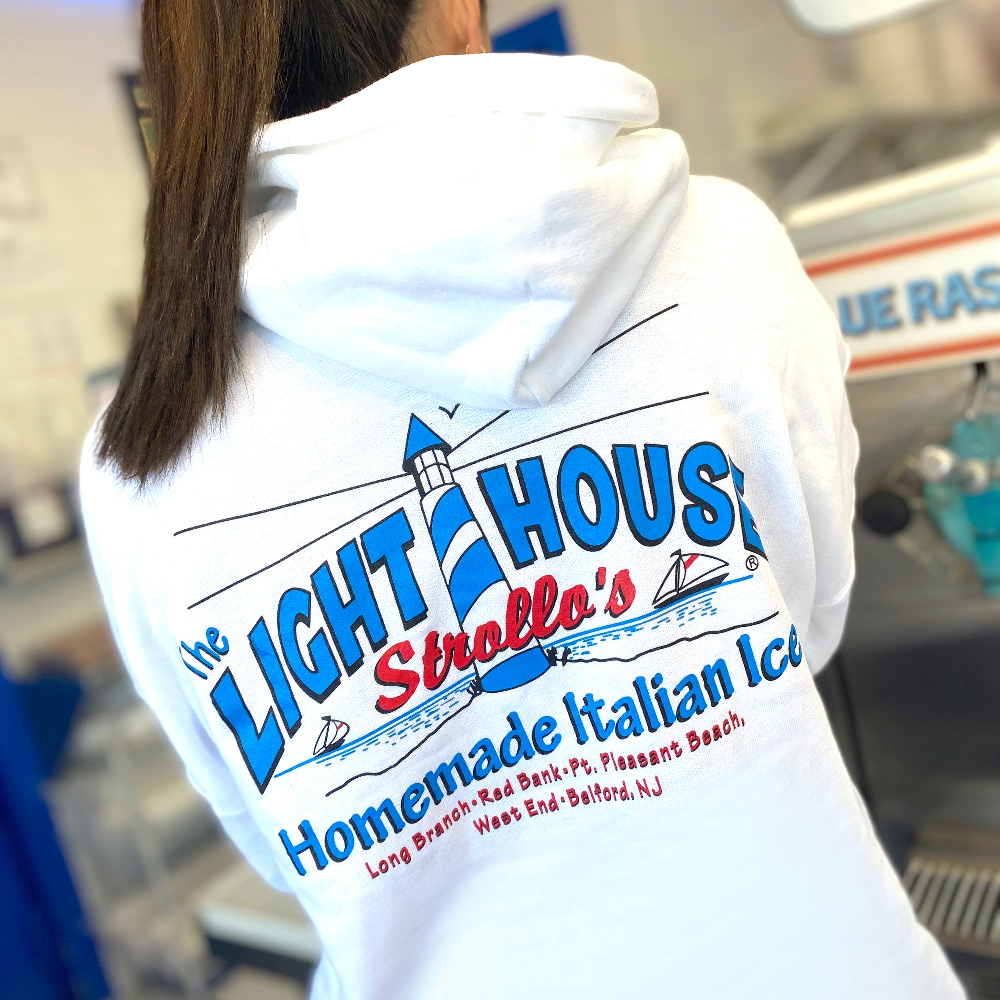A Strollo's Lighthouse white hoodie with the logo on the back
