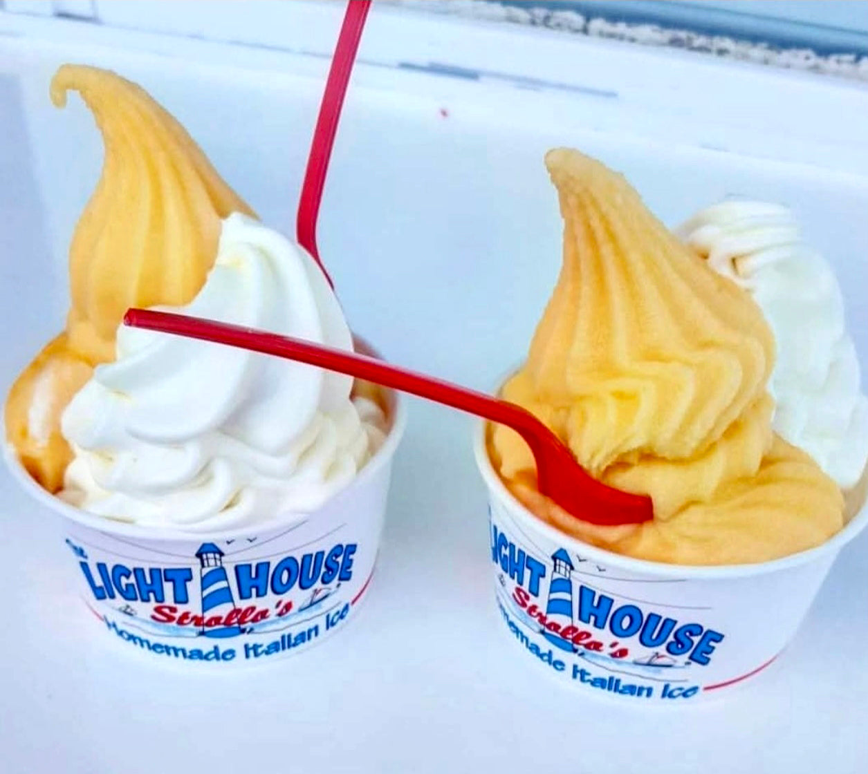 Two Strollo's Lighthouse cups with mango homemade Italian Ice and coconut soft serve ice cream