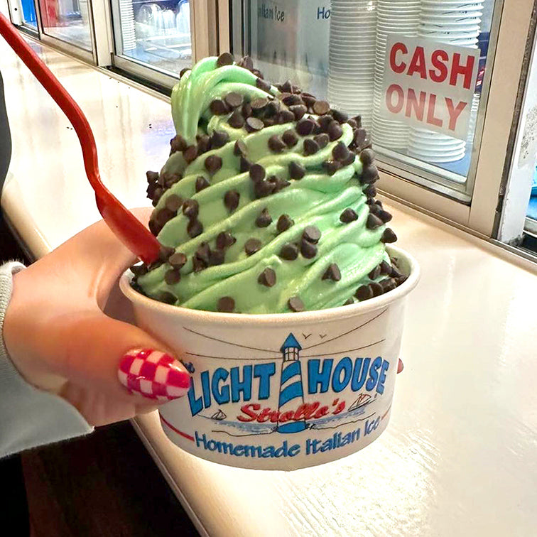 A Strollo's Lighthouse cup with soft serve mint ice cream with chocolate chips topping