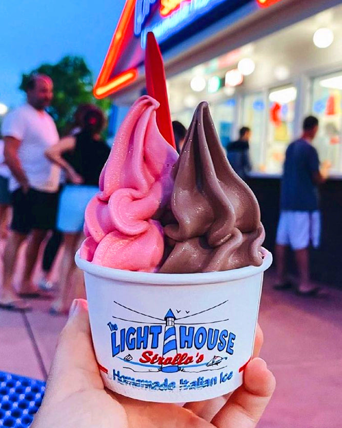 A Strollo's Lighthouse cups with cherry homemade Italian Ice and chocolate soft serve ice cream