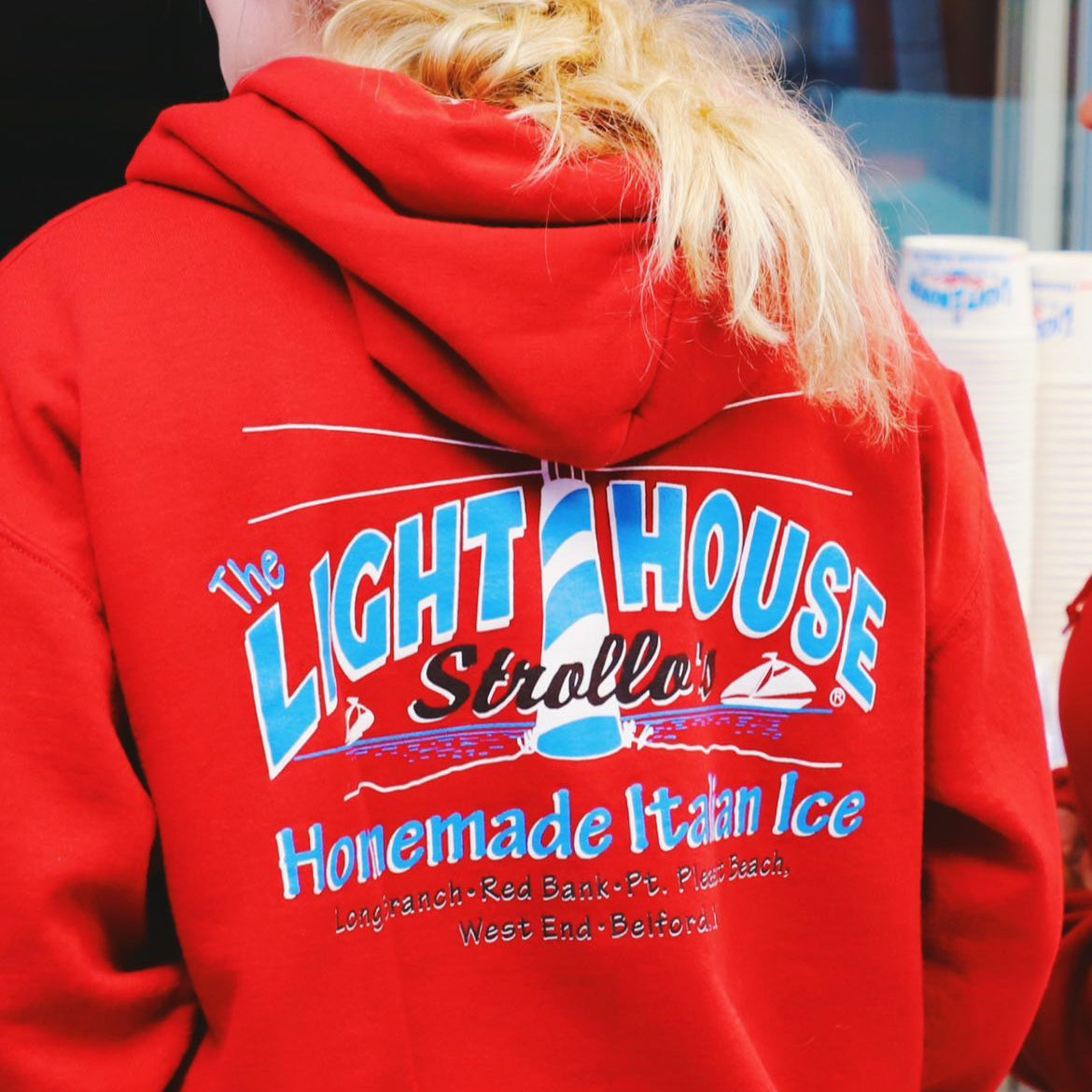 A Strollo's Lighthouse red hoodie with the logo on the back